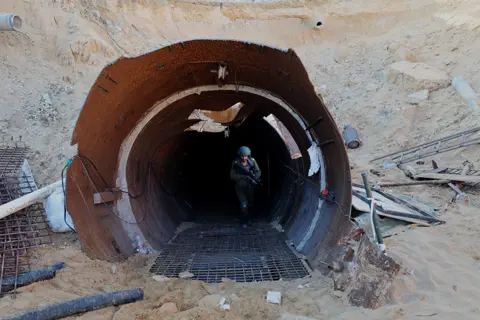 AFP In this picture taken during a media tour organized by the Israeli military on December 15, 2023, an Israeli soldier exits a tunnel that Hamas reportedly used to attack Israel through the Erez border crossing on October 7.