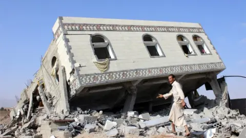 Reuters Man walks on rubble after a Saudi-led air strike on Sadaa (file photo)