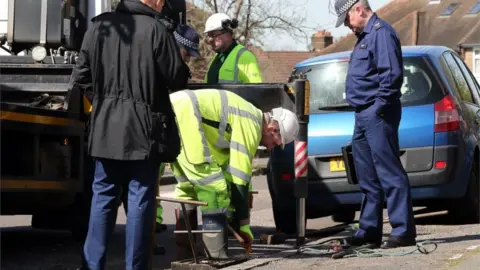 PA Forensic officers investigate the drains near the scene in South Park Crescent in Hither Green