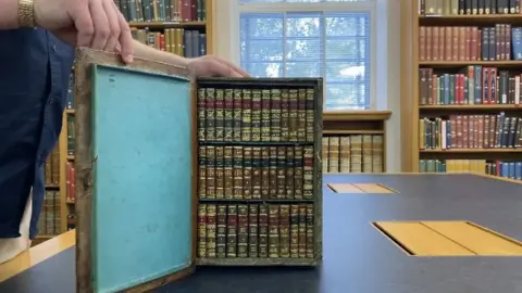 Natalie Malcolm/BBC Travelling library opened up to show the small books inside