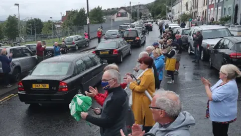 Niall Carson Members of the public lined the streets and clapped as John Hume's funeral cortege passed through the city.