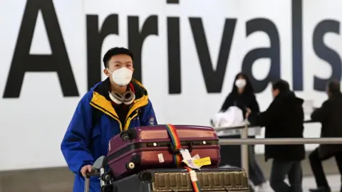 ANDY RAIN/EPA-EFE/REX/Shutterstock Man arriving from China to London Heathrow on January 4, 2023.