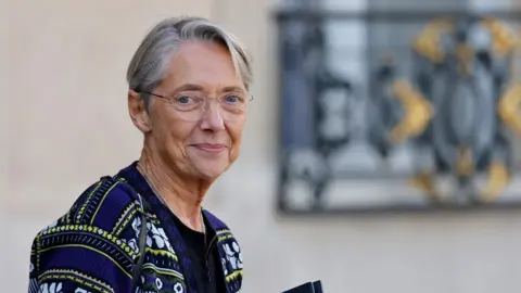 Getty Images France's Prime Minister Elisabeth Borne leaves after the weekly cabinet meeting at the presidential Elysee Palace in Paris on October 12, 2022.