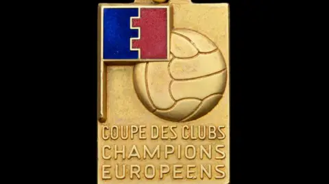 Bonhams A close-up photo of the 1968 European Cup medal with a football on the gold medal with the words: "Coupe des Clubs Champions Europeens"