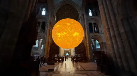 A giant yellow ball - suspended from the ceiling of the Cathedral.