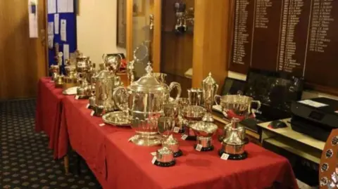 Minto Golf Club An empty trophy cabinet with a smashed glass front