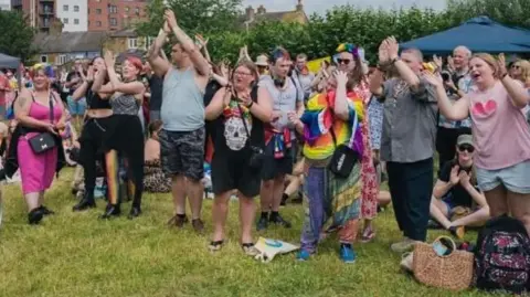 Peterborough Pride Pride festival-goers applauding