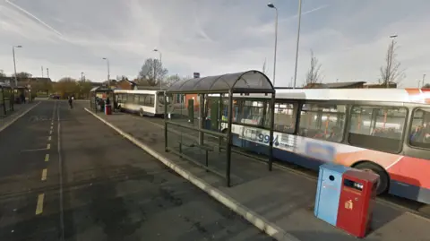 Town bus station with buses waiting at the stands