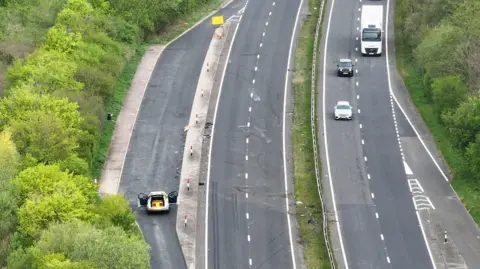 Eddie Mitchell Aerial view of dual carriageway with cars and lorry on it