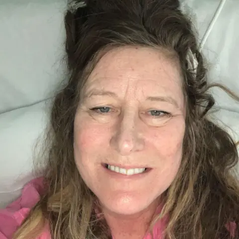 Lucy Marshall Lucy takes a selfie from above on her hospital bed, post-surgery.