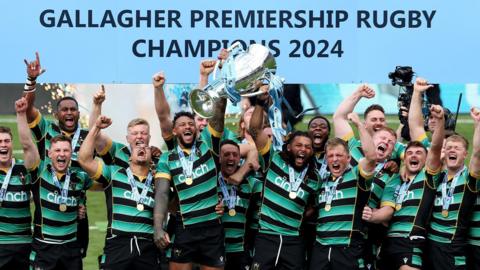Northampton players lift the Premiership trophy