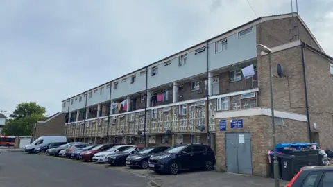 Emily Coady-Stemp/BBC The outside of a building on the Lakeview estate which shows where the external cladding has been removed on a lower level of the homes
