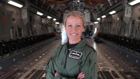 Wing Cdr Nicola Lofthouse stood in the hangar bay of an A400 aircraft.