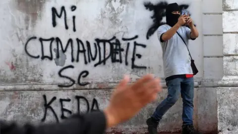 AFP A supporter of under-pressure Nicaraguan President Daniel Ortega films outside the San Sebastian Basilica in Diriamba, Nicaragua, on July 9, 2018