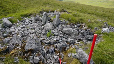 Yorkshire Dales National Park Authority Image showing what remains of what would have been chambers within the cairn when it was intact.