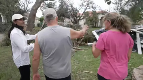 Sumi Somaskanda speaking with Wellington residents aft  a tornado