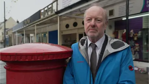 BBC Alan Bates next to a postbox