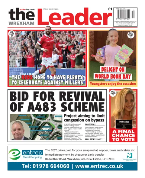 Wrexham Leader Front page of the Wrexham Leader newspaper. The main headline reads: Bid for revival of A483 scheme. There is a picture of a road and a man with short grey hair below the headline. At the top is a picture of a football player wearing a red strip and running on a pitch with fans behind him. The writing reads: "The reds hope to have plenty to celebrate against Millers". Another story at the top has a picture of a young girl smiling and holding a book with the writing: "Delight on World Book Day, youngsters celebrate the occasion." In the bottom right corner is a picture of a blonde woman which says "A final chance to vote". Along the very bottom of the page is a blue and white advert for Entrec Metal Recycling