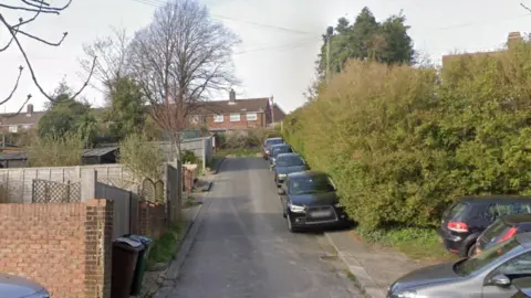 Google A row of vehicles are parked on a sloped curb at Southmount, Hollingdean.
