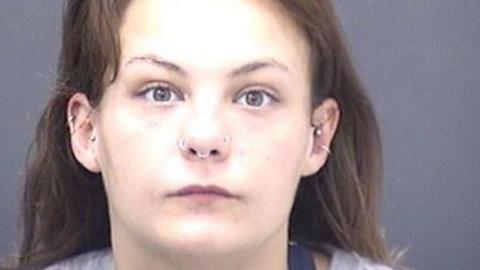 Police custody photo of Jessica Berry who has long brown hair and multiple piercings in her nose and ears