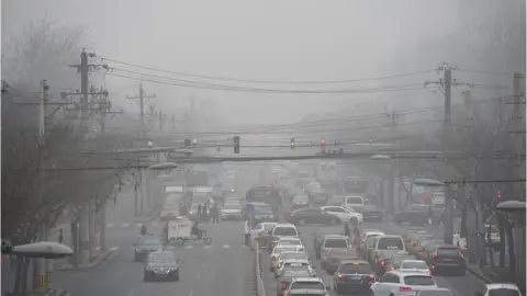 AFP/Getty Cars drive below a blanket of smog on a heavily polluted day in Beijing on December 26, 2015