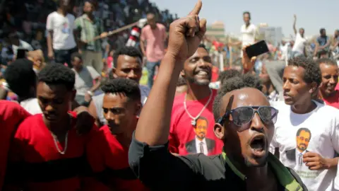 Reuters Supporters of Bekele Gerba, secretary general of the Oromo Federalist Congress (OFC), chant slogans to celebrate his release from prison, in Adama, Oromia Region, Ethiopia, 14 February 2018