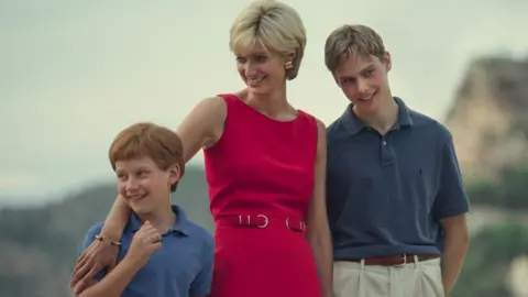 Netflix Production still image of Elizabeth Debicki as Princess Diana with Fflyn Edwards as young Prince Harry (l) and Rufus Kampa as young Prince William (r) in the final season of The Crown