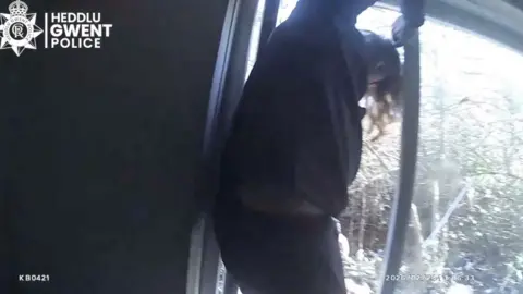 man jumping out of window 