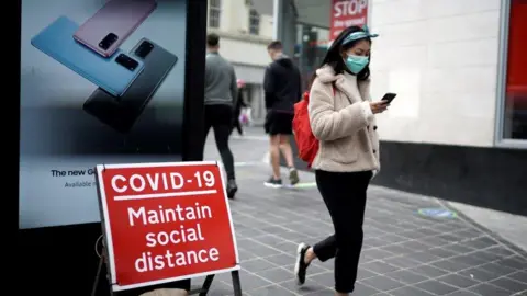 Getty Images A woman wears a face mask on the high street on July 14, 2020