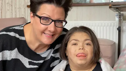 Jamie Niblock/BBC Seven-year-old Erin and her mother Helen Sadler