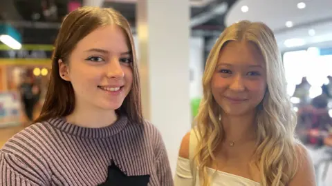 Two young women smiling at the camera