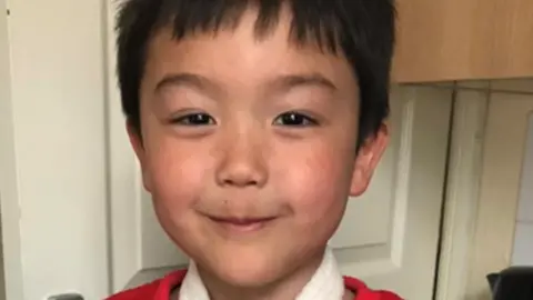 Family photo William Gray holding toys