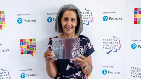 Pearson National Teaching Awards Manjit Nahal holding an award