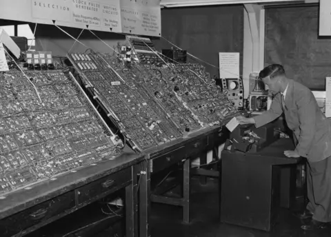 Getty Images Man using a massive computer in 1956