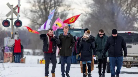 Reuters Indigenous Services Minister Marc Miller walks with representatives of the Mohawk Nation