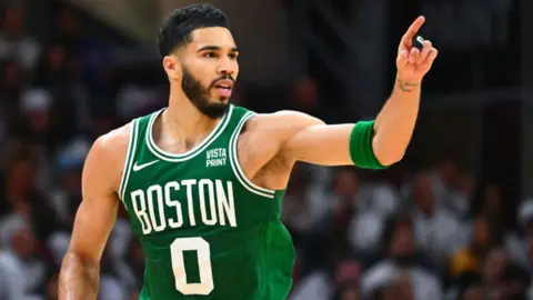 Boston Celtics forward Jayson Tatum gestures to his team-mates