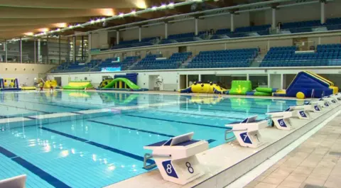 Bangor Aurora Swimming Pool. a number of lanes are visible and an empty seating area is in the background