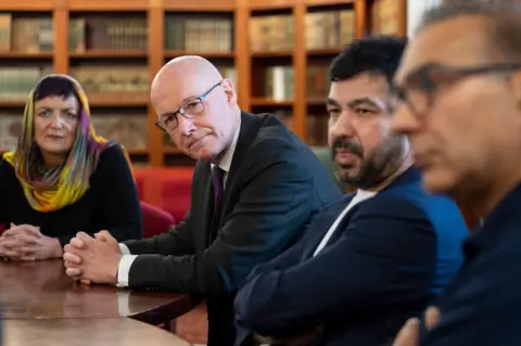 PA Media First Minister John Swinney met with Imam Habib Rauf and members of the Muslim community at Edinburgh Central Mosque, to provide reassurances following the incidents of unrest seen in other parts of the UK