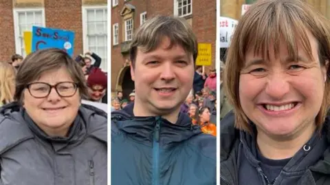 Lucinda Adam/BBC On the left, Debbie has short brown hair and glasses and wears a grey coat. In the middle, Matthew has very short brown hair and wears a dark green waterproof coat. On the right, Alison has reddish-brown hair in a bob with a fringe. She wears a black coat over a black hoodie jumper. All three are smiling. 