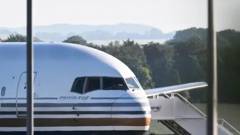 Getty Images Chartered jet ready to take asylum seekers to Rwanda