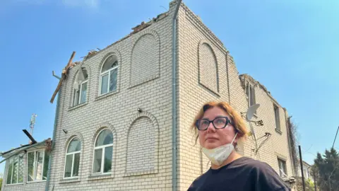 BBC A woman and her destroyed home