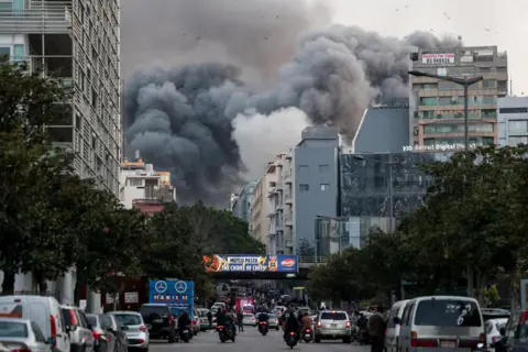 Reuters Smoke rises following an Israeli strike on a building in Beirut's central Bachoura neighbourhood, Lebanon (12 March 2026)