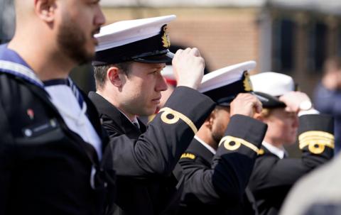 Members of the Royal New Zealand Navy replace their caps