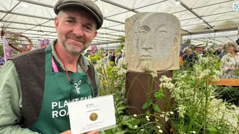Paul Seaborne with his winner certificate and display at Chelsea Flower Show 2024