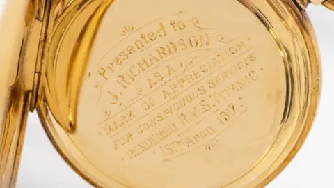 Hansons Auctioneers Close-up of a gold watch, engraved: "Presented to J. Richardson as a mark of appreciation for conspicuous services rendered R.M.S. Titanic, 15th April 1912.” 