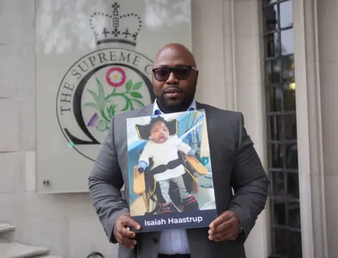 Yui Mok/PA Wire Lanre Haastrup, father of Isaiah Haastrup, outside the Supreme Court in London