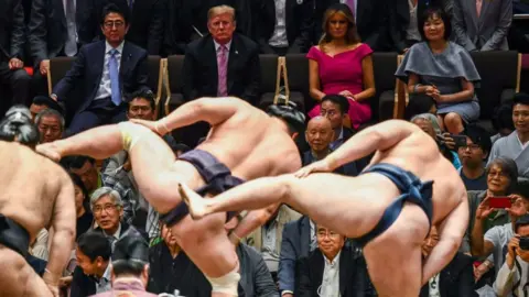 Getty Images Donald Trump and First Lady Melania Trump watch a sumo battle. 26 May 2019