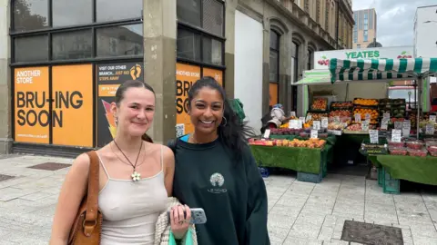 University students outside a food stall along Queen Street