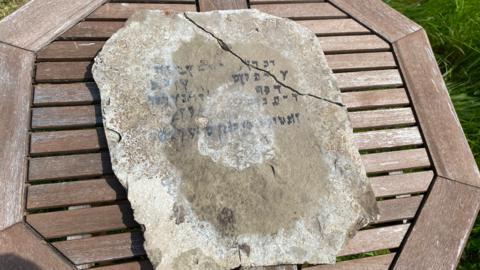 Stone slab with Hebrew writing on it