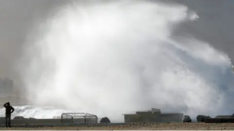AFP Man watches waves at beach in Marseille, France - 4 January